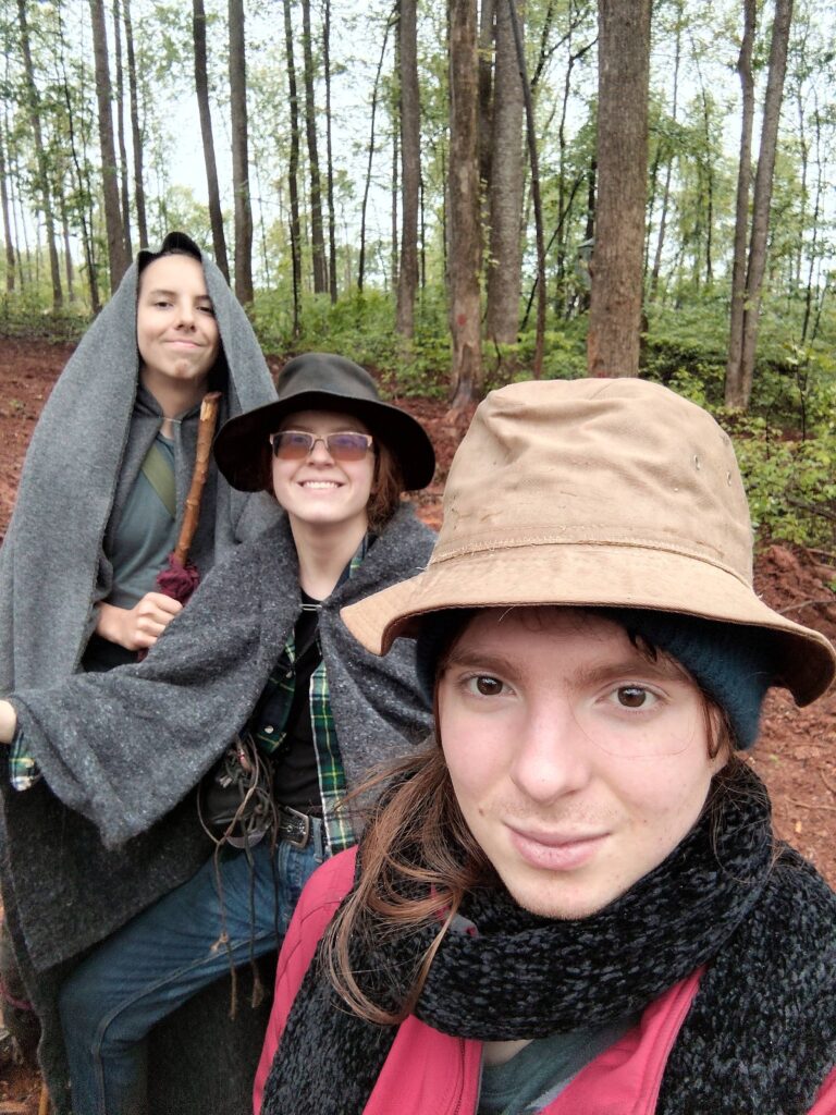 Eric and his two sibling on a walk in a forest after a rainshower.