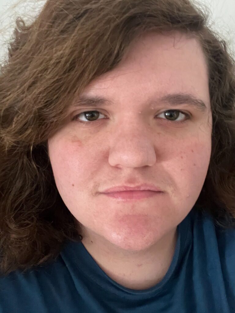 Picture of a early 20s man with brown hair and brown eyes.